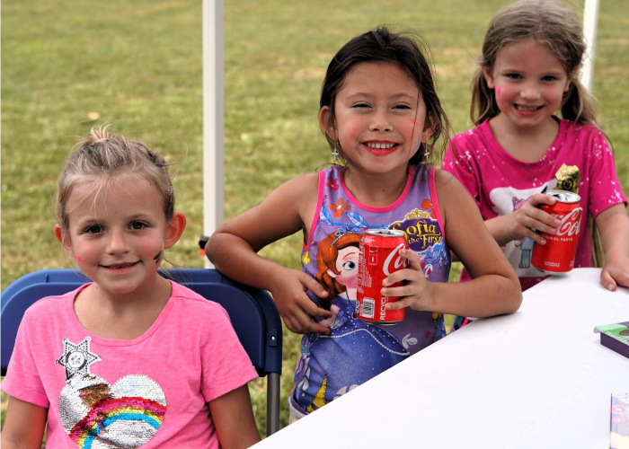 Three elementary aged girls enjoy a Coca Cola at BMH's Back-to-School Bash
