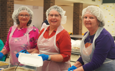Three volunteers filling food boxes at the BMH 4th Annual Community Drive-Thru Thanksgiving Dinner