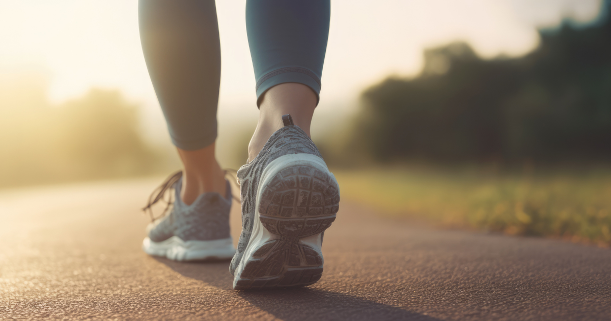 Closeup photo of a woman's sneakers as she walks outside on a path