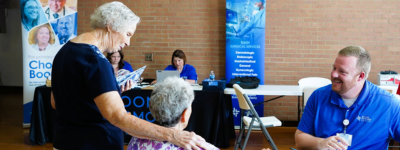 Photo of BMH Employee talking to two senior women