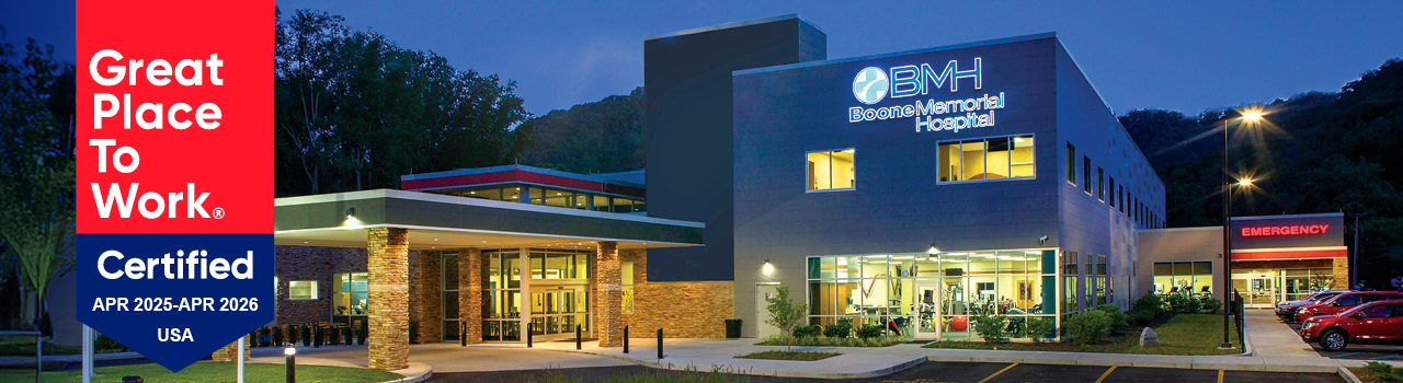 Nightime photo of Boone Memorial Hospital's exterior, layered with the hospital's Great Place to Work Certification badge