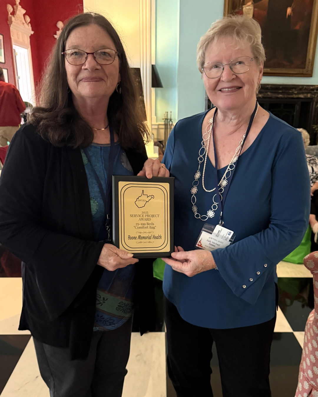 Diana Dunlap (left) and Judy Michael, President of the BMH Auxiliary (right) photographed with a recognition plaque earned by the BMH Auxiliary from the AWVHA.