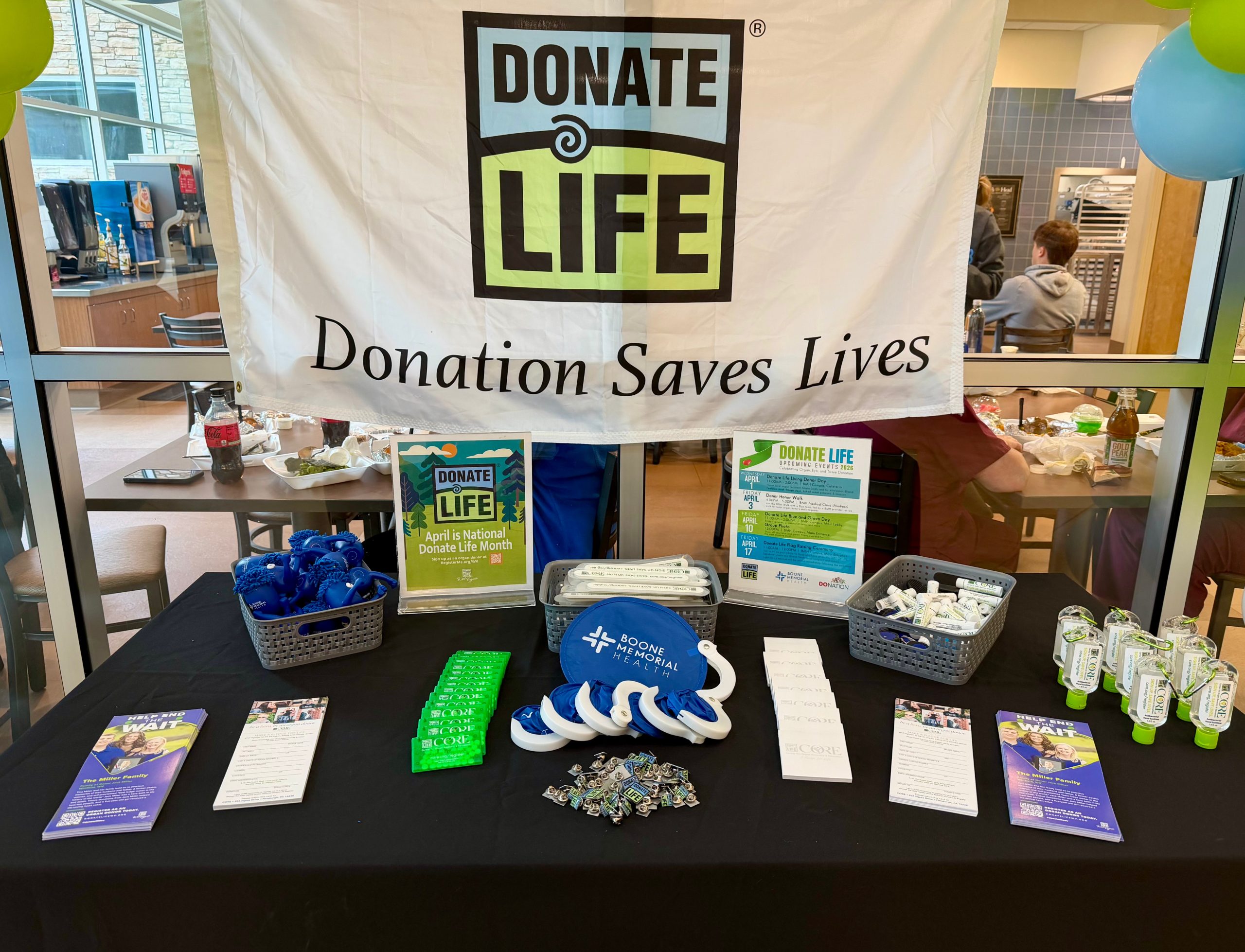 Donate Life table display at Boone Memorial Health featuring a banner reading “Donate Life – Donation Saves Lives,” and giveaways and materials