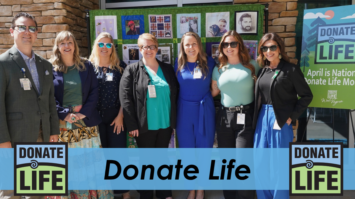 BMH staff members standing together outdoors in front of a Donate Life display, with text overlay reading “Donate Life” and Donate Life logos