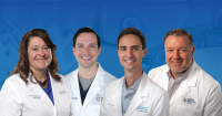 Group portrait of orthopedic and sports medicine providers from Boone Memorial Health and Vandalia Health, wearing white medical coats and smiling toward the camera.