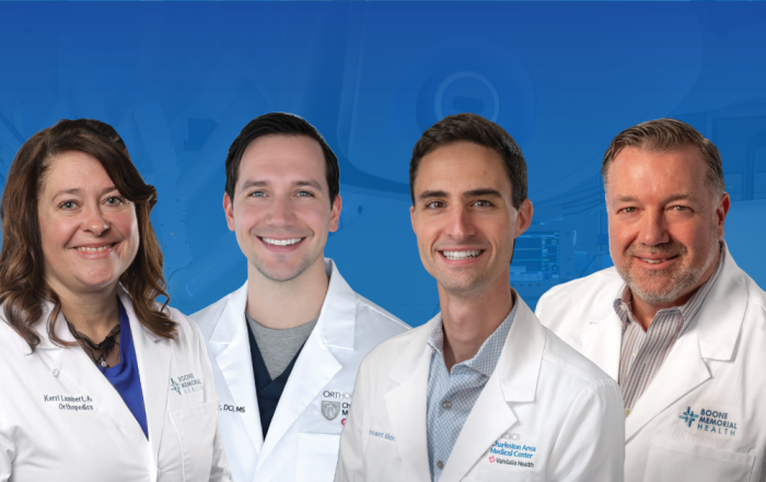 Group portrait of orthopedic and sports medicine providers from Boone Memorial Health and Vandalia Health, wearing white medical coats and smiling toward the camera.